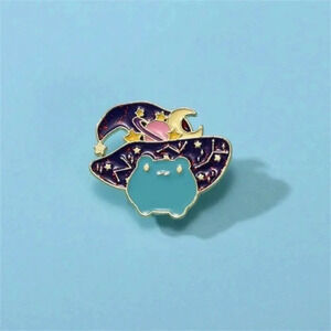 Cute Halloween cartoon teal frog with black wizard hat moon stars enamel pin